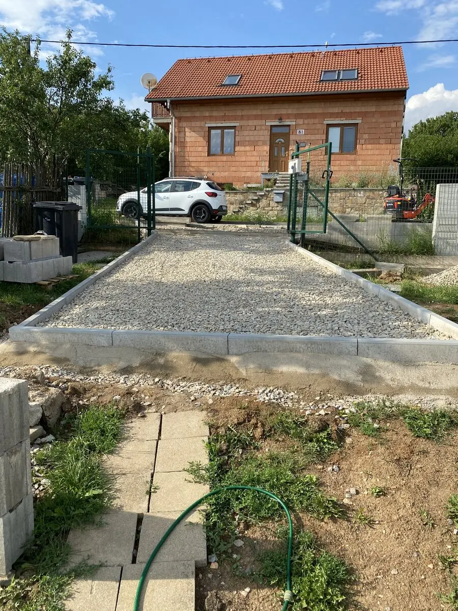 Štěrkové lože stání, dům v pozadí, Biskoupky